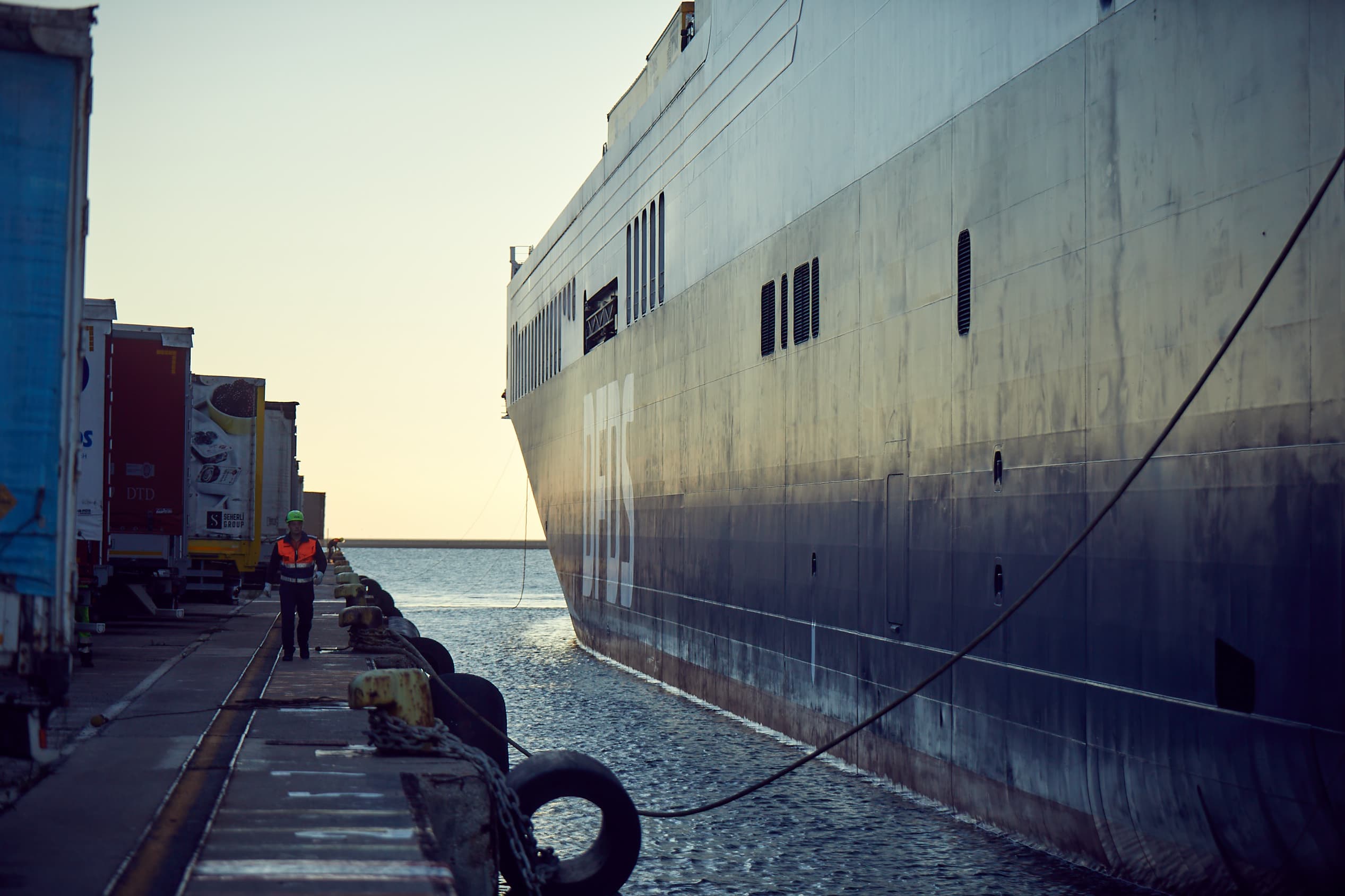 An employee walks along a DFDS ship docked at Trieste