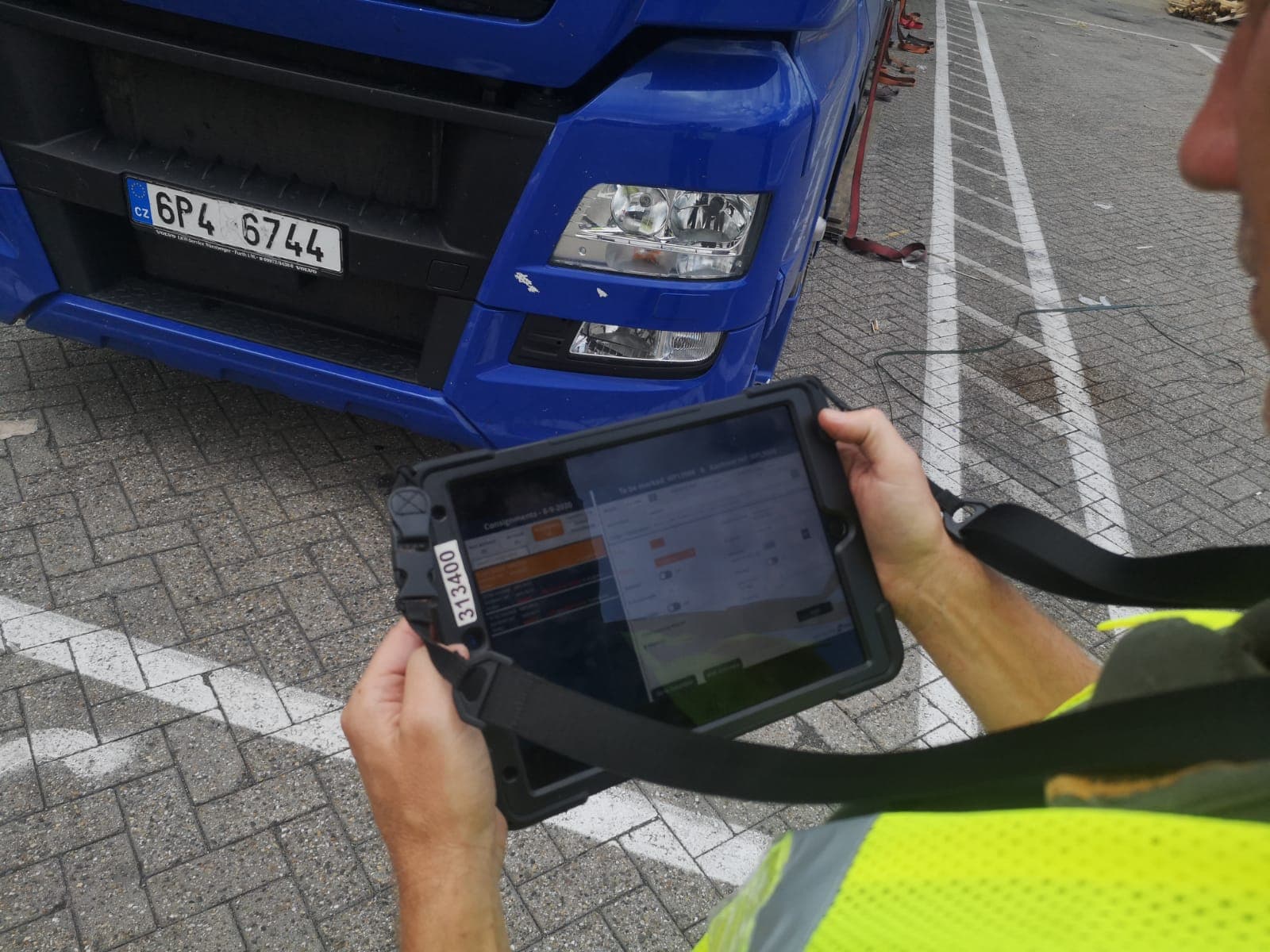 DFDS Shipping Logistics Coordinator using a tablet at Vlaardingen terminal.