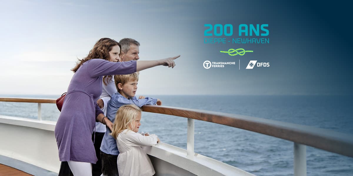 Woman pointing at something in the distance with her family on the deck of the DFDS ferry