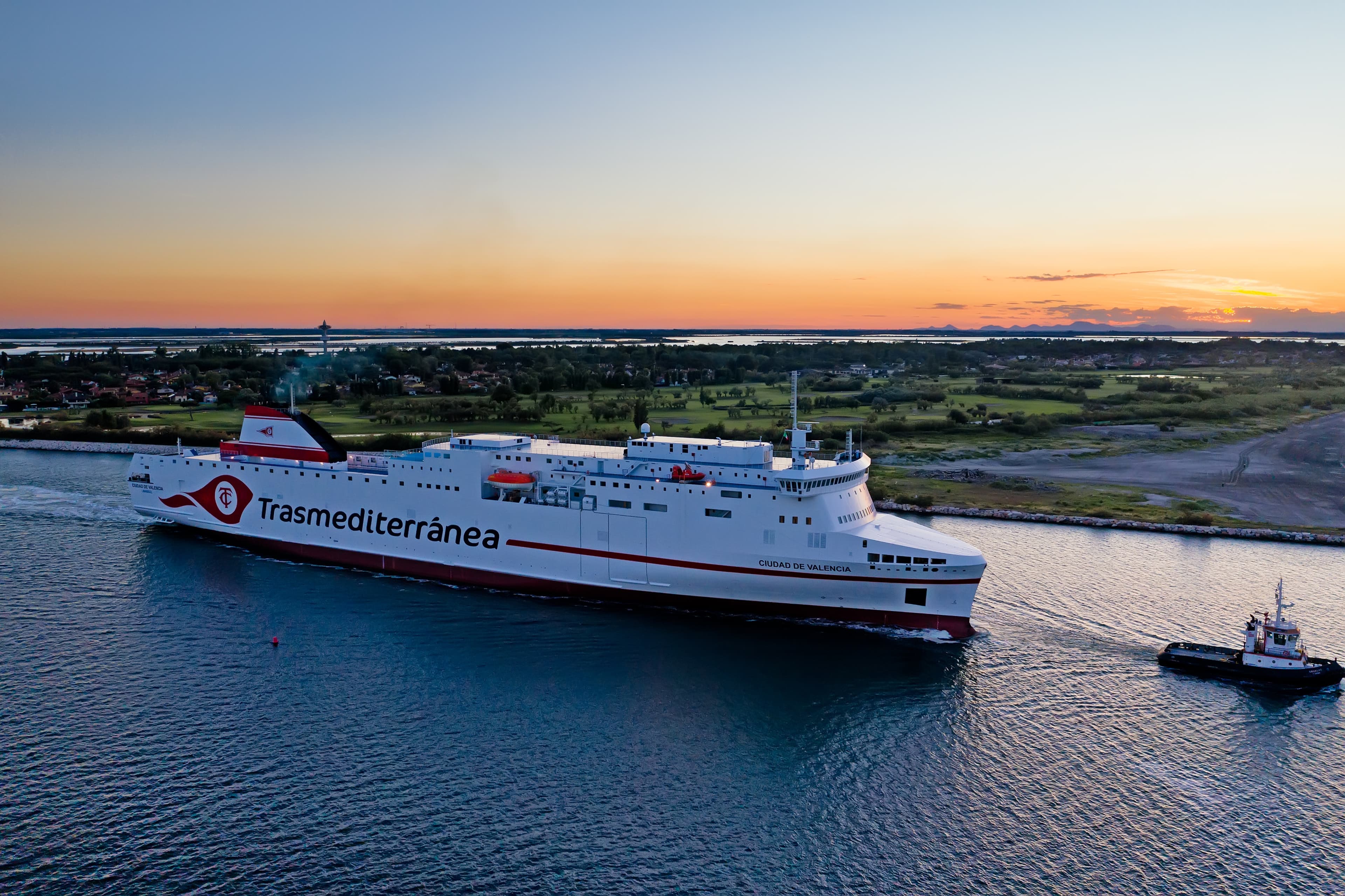 A done shot from the side of the Chartered vessel Ciudad de Valencia being tugged at sunset.