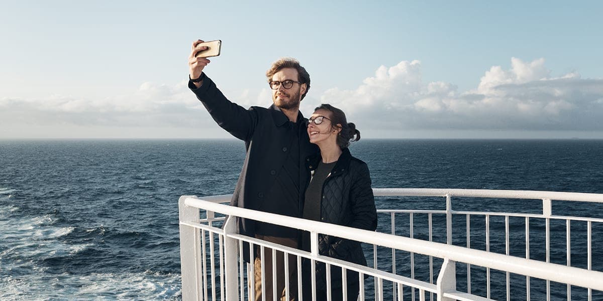 Couple on deck onboard DFDS ferry taking a selfie