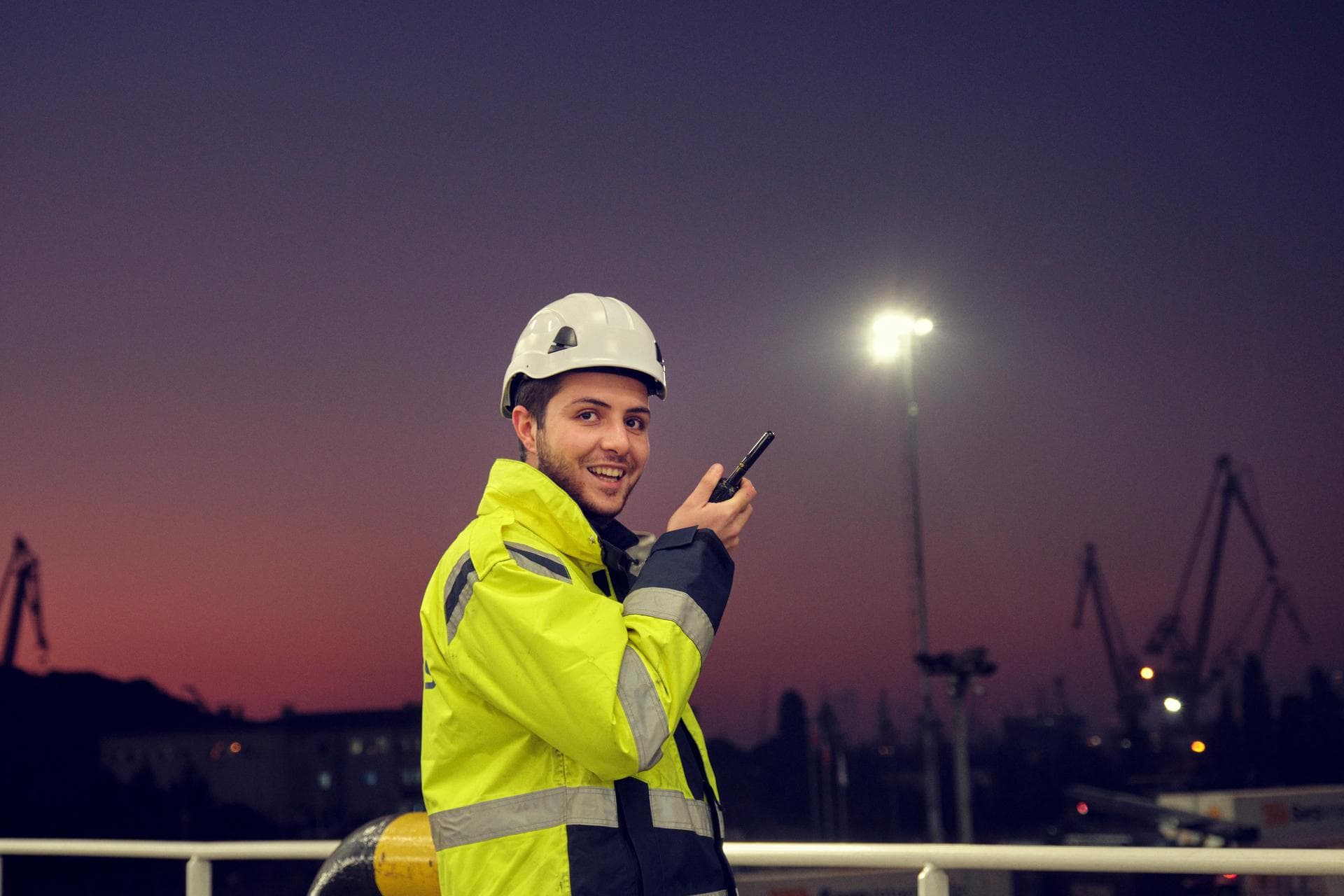 DFDS worker at port talking on a radio.