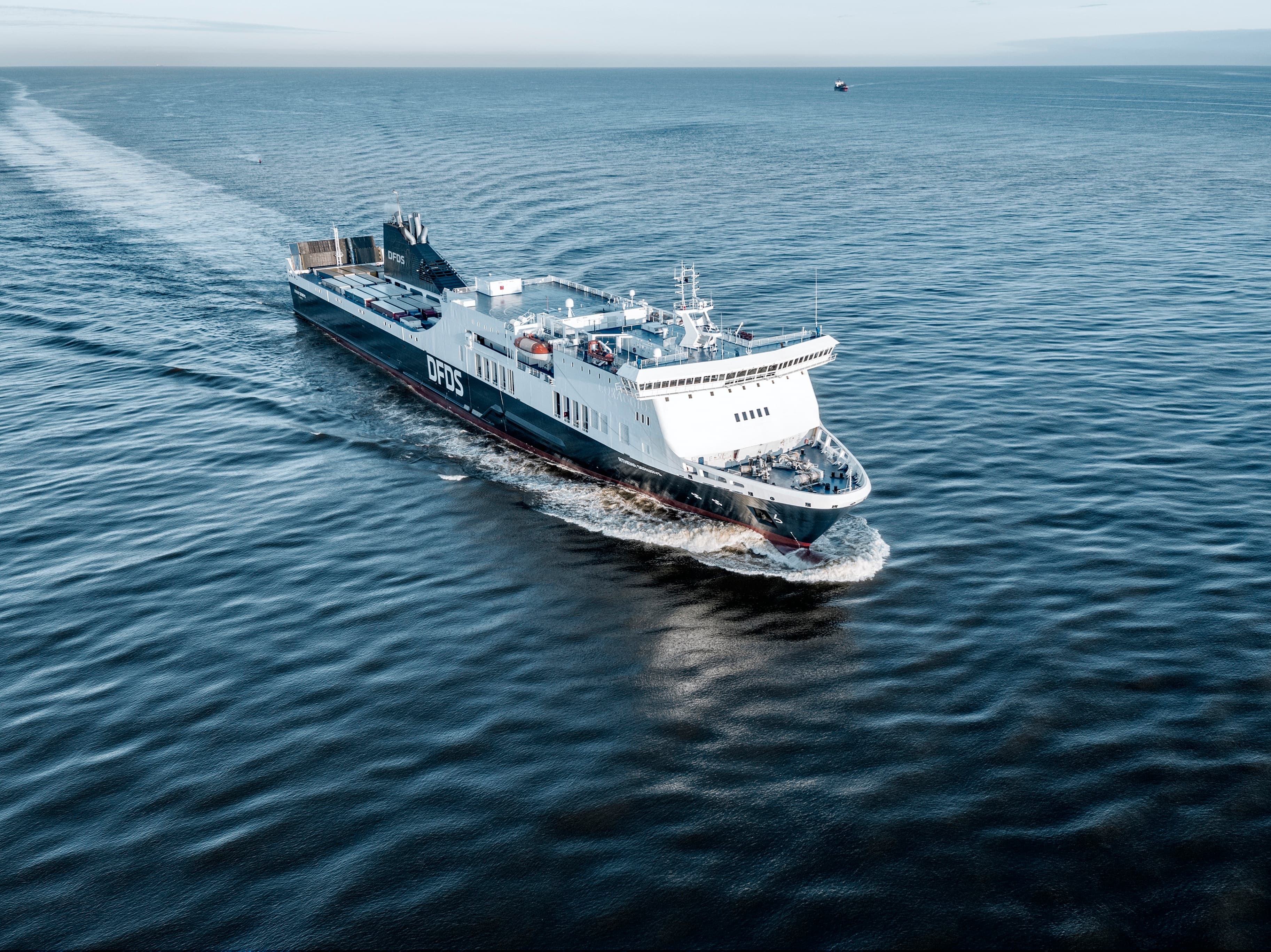 A drone shot from an angle above of the DFDS vessel Athena Seaways on the open sea
