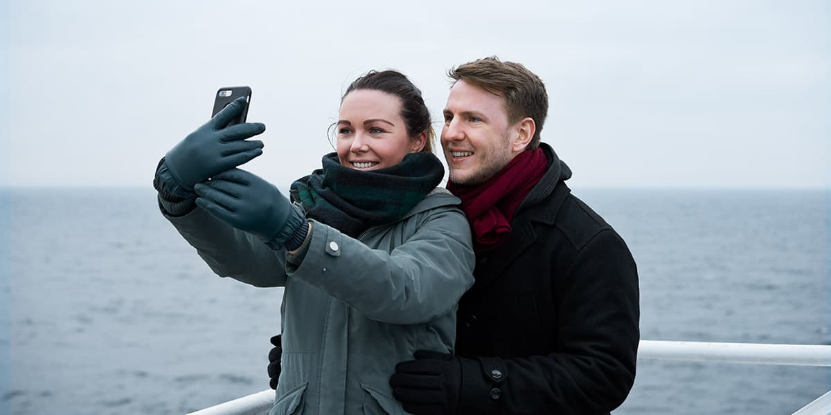 Couple watching the horizon on deck