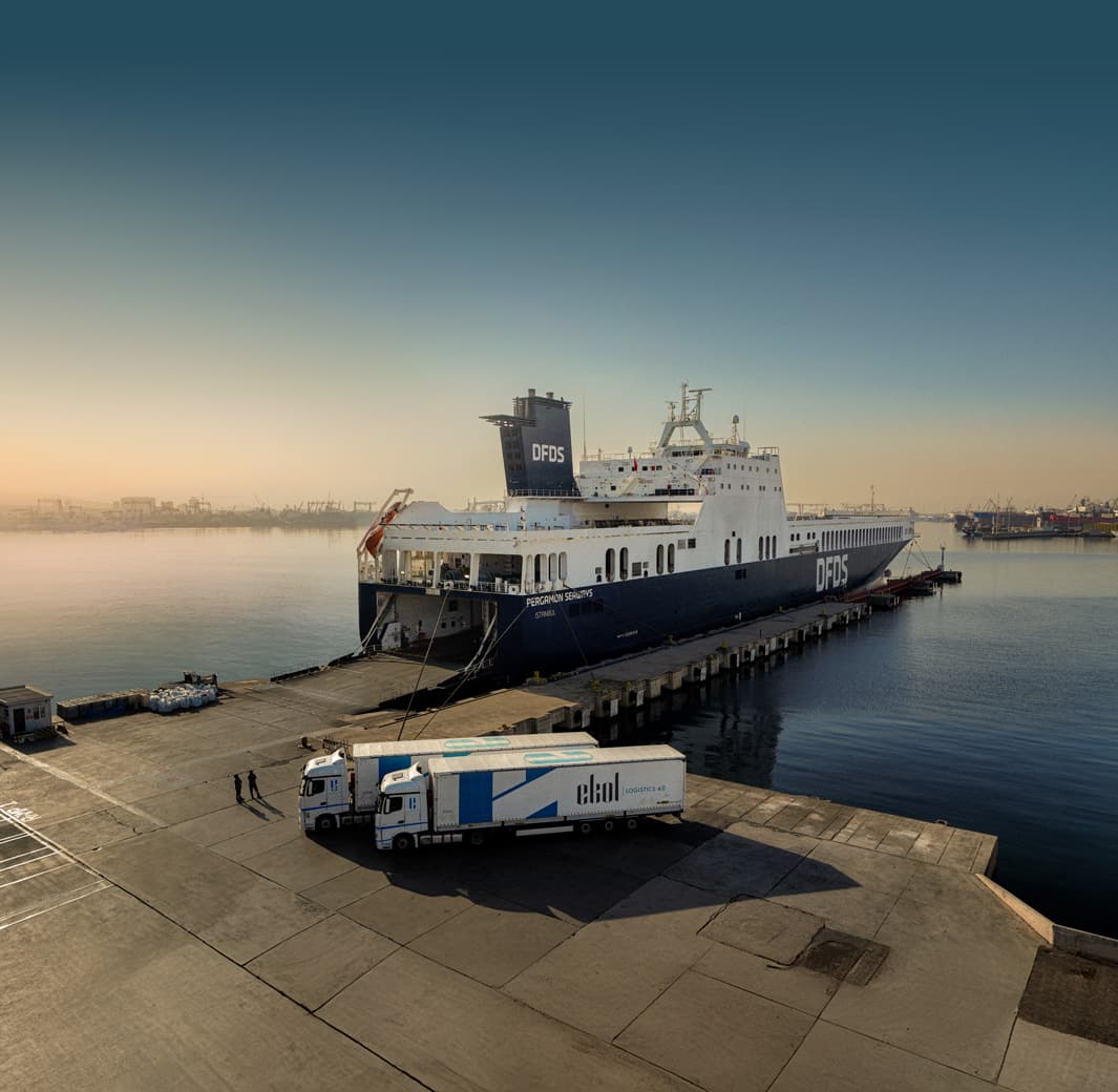 Ekol International Transport is acquired by DFDS. An Ekol International Transport truck and a DFDS ship at the port.