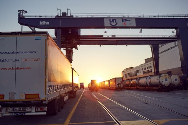 Logistics trucks entering a DFDS Freight terminal in Türkiye, at dusk