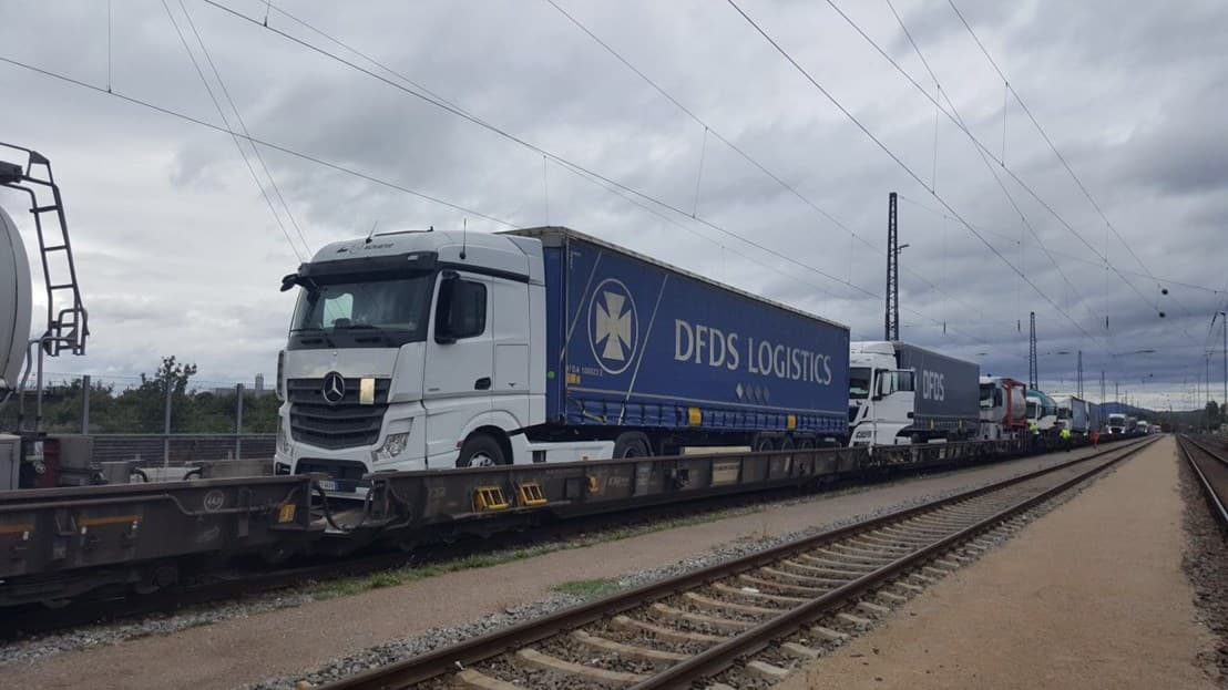 DFDS Logistics trucks loaded on rail cars